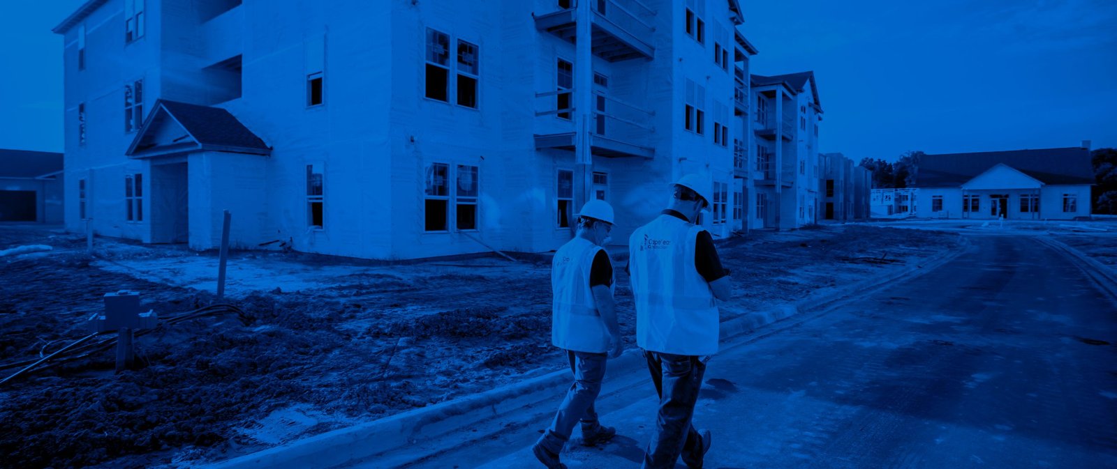 Construction workers walking through site